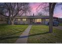 Charming home featuring a welcoming front porch and well-manicured lawn, perfect for relaxing evenings at 10150 W 25Th Ave, Lakewood, CO 80215
