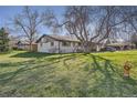 Charming single-story home featuring mature trees, a spacious lawn, and inviting curb appeal at 10150 W 25Th Ave, Lakewood, CO 80215