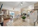 Bright and airy living room and dining area featuring wood floors and modern decor at 1272 S Uvalda St, Aurora, CO 80012