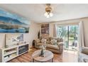 Cozy living room with a fireplace, flatscreen TV, and sliding door to the outdoor space at 1272 S Uvalda St, Aurora, CO 80012