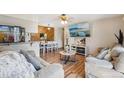 Inviting living room with views into kitchen and dining, plus comfortable seating and wood flooring at 1272 S Uvalda St, Aurora, CO 80012