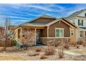 Beautiful single-Gathering home featuring stone accents and a cozy front porch at 4322 N Meadows Dr, Castle Rock, CO 80109