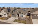Overhead view of a well-manicured lawn, neutral-colored single-story home, and a two-car garage at 8390 S Cody Way, Littleton, CO 80128