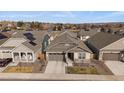 Aerial shot of a neighborhood street highlighting attractive landscaping and single-story homes with solar panels at 8390 S Cody Way, Littleton, CO 80128