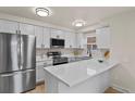 Modern kitchen featuring stainless steel appliances, white quartz countertops, and ample cabinet space at 14585 W 32Nd Ave, Golden, CO 80401