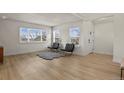 Bright living room with light wood floors, white walls, and large windows, creating an inviting space at 14585 W 32Nd Ave, Golden, CO 80401