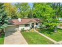 Inviting single-story home showcasing beautiful landscaping, a large lot and mature trees at 2237 Zinnia St, Golden, CO 80401