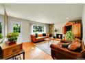 Cozy living room features a stone fireplace, hardwood floors, and comfortable seating at 2237 Zinnia St, Golden, CO 80401