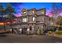 Elegant multi-story home showcasing a three-car garage, stone accents, and a well-maintained driveway at 32569 El Diente Ct, Evergreen, CO 80439