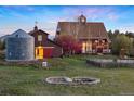 Scenic view of home's exterior, complete with a charming pond and lush greenery at 11689 Caribou Dr, Franktown, CO 80116