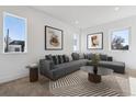 Comfortable living room with a large sectional sofa, stylish decor, and plenty of natural light at 3432 W 25Th Ave, Denver, CO 80211