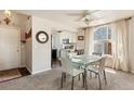 Open dining area with modern table, light-filled arched window, and seamless flow to the kitchen at 19917 Mitchell Cir, Denver, CO 80249