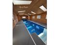 Indoor pool featuring natural lighting and cedar wood walls at 2100 Bibles Hill Dr, Franktown, CO 80116