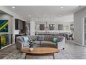Open-concept living space with a stylish couch, modern lighting, and seamless flow to the kitchen at 5290 Silver Hare Ct, Castle Rock, CO 80104