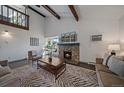 Inviting living room featuring vaulted ceilings, a stone fireplace, wood beams and balcony overlook at 4068 S Atchison Way # 301, Aurora, CO 80014