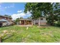 The backyard offers a covered patio and lots of space for outdoor activities and relaxation at 1161 S Johnson Way, Lakewood, CO 80232