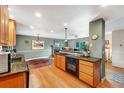Spacious kitchen with wooden cabinets and countertops, seamlessly flowing into the adjacent living area at 1161 S Johnson Way, Lakewood, CO 80232