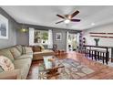 Cozy living room featuring a large window, sliding glass door, and ceiling fan at 1711 Cato Cir # 21, Lafayette, CO 80026