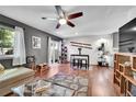 Open-concept living room with hardwood floors, stylish decor, and a ceiling fan at 1711 Cato Cir # 21, Lafayette, CO 80026