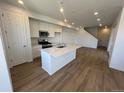 Modern kitchen with island and stainless steel appliances at 6608 N Nepal Ct, Aurora, CO 80019