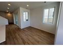 Bright living room with sliding glass doors and wood-look floors at 6608 N Nepal Ct, Aurora, CO 80019