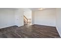 Living room featuring wood-look floors and an open staircase at 3124 W 9Th Avenue Pl, Broomfield, CO 80020