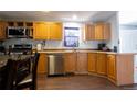 The kitchen features stainless steel appliances and wood cabinets at 4210 E 100Th Ave # 478, Thornton, CO 80229