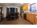 The kitchen features stainless steel appliances, a dining table, and wood cabinets at 4210 E 100Th Ave # 478, Thornton, CO 80229