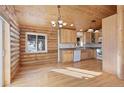 Kitchen with wood cabinets, granite countertops and wood flooring at 721 Aspen Way, Evergreen, CO 80439