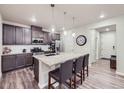 Stylish kitchen featuring granite countertops, modern appliances, and a breakfast bar with seating at 6153 N Ceylon St # 2-202, Denver, CO 80249