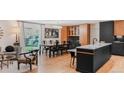 Modern kitchen with island, dark cabinetry, and hardwood floors at 4600 W Princeton Ave, Denver, CO 80236