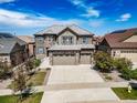 Beautiful two-story home featuring an attached three car garage and landscaped yard at 7720 S Queensburg Way, Aurora, CO 80016