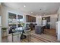 Modern kitchen with stainless steel appliances, granite countertops, wooden cabinets and a sliding door to the patio at 1100 Blue Bell Rd, Berthoud, CO 80513