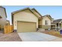 Exterior elevation of a home featuring a two-car garage, concrete driveway and modern fixtures at 4102 Estrella St, Brighton, CO 80601