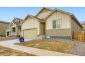 New construction home with a two-car garage and light brown exterior at 4102 Estrella St, Brighton, CO 80601