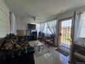 Comfortable living room featuring tile floors and an open view of the front yard at 7371 Granada Rd, Denver, CO 80221