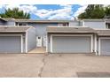 Exterior view of the townhome with gray siding, attached garages, and well-maintained landscaping at 2856 S Kenton Ct, Aurora, CO 80014