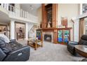 Spacious living room boasts a grand fireplace and open floor plan at 7645 Fox Creek Trl, Franktown, CO 80116