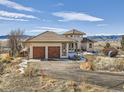 Lovely stucco home with tile roof and two-car garage, offering picturesque views at 8611 Coachlight Way, Littleton, CO 80125