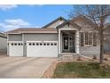 Charming two-story home with a two car garage and a well-maintained front yard at 9080 Fig St, Arvada, CO 80005