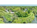The walking trail leads to a wooded area with mature trees and a nearby creek at 8032 Lee Ct, Arvada, CO 80005