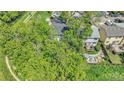A high angle view of a lush backyard that includes a patio, trees, a deck and a walking trail at 8032 Lee Ct, Arvada, CO 80005