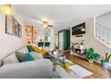 Comfortable living area featuring a large sofa, open kitchen, and natural light at 338 Pheasant Run, Louisville, CO 80027