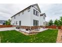 The backyard has a well-maintained lawn and stone accents, offering a private outdoor space at 690 W 172Nd Pl, Broomfield, CO 80023