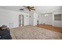 Bright living room featuring neutral carpet, and white walls, and an adjoining dining space at 1299 S Dale Ct, Denver, CO 80219