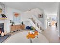 Open concept living room featuring modern decor, a fireplace, and staircase with white railing at 9658 W Chatfield Ave # D, Littleton, CO 80128