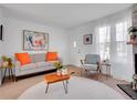 Cozy living room with bright pillows, decor, and a fireplace, offering a relaxing and stylish area at 9658 W Chatfield Ave # D, Littleton, CO 80128