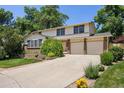 Charming two-story home with a well-manicured lawn, mature trees, and a two-car garage at 9025 Jellison Ct, Broomfield, CO 80021