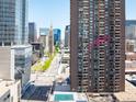 Exterior building view with the unit highlighted by an arrow and views of the downtown Denver skyline at 1020 15Th St # 20N, Denver, CO 80202
