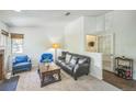 Bright living room with soft carpeting, stylish furniture, with lots of natural light and open doorway at 1111 S Garrison St # 202, Lakewood, CO 80232